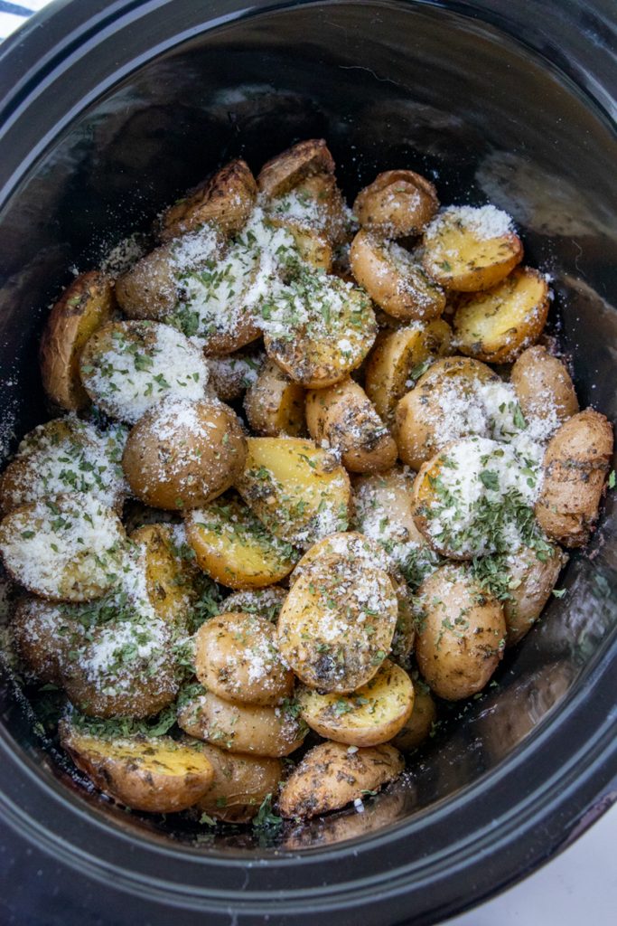 baby potatoes with ranch dressing and parmesan cheese in a crockpot