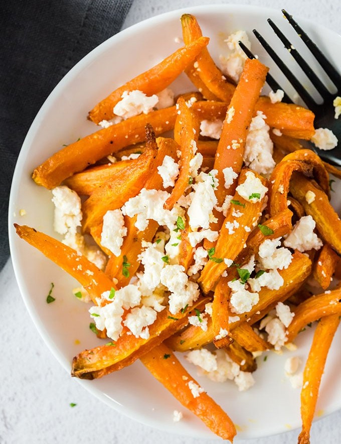 Air Fryer-Roasted Curry Carrots with Feta Cheese on a white plate