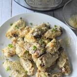 Instant Pot Garlic Butter Parmesan Chicken Wings on a white plate