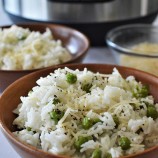 Instant Pot Parmesan Rice and Peas is fluffy, cheesy, and makes a great dinner side dish. Quick and easy to make in the pressure cooker, it's perfect for busy weeknights. on wooden bowls