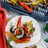 Air Fryer Steak Fajitas with bell peppers on flour tortilla