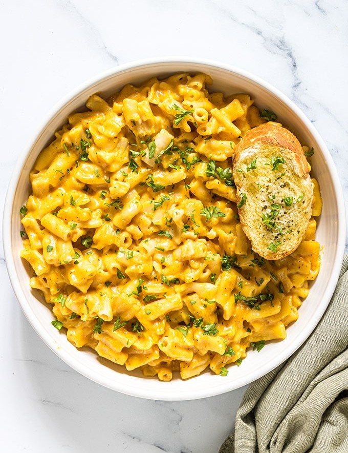 pressure cooker pumpkin macaroni and cheese in a white bowl