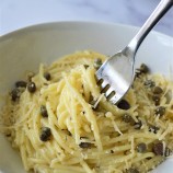 eating garlic butter pasta with a fork