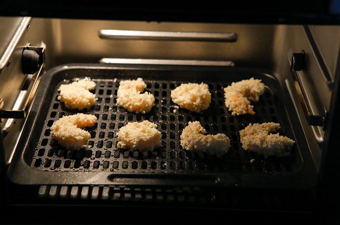 panko-coated shrimp crisping in the air fryer