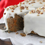serving slice of pressure cooker carrot cake on a cake stand