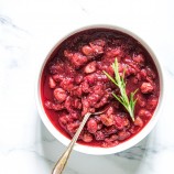 Instant Pot Cranberry Sauce in a bowl with a herb sprig